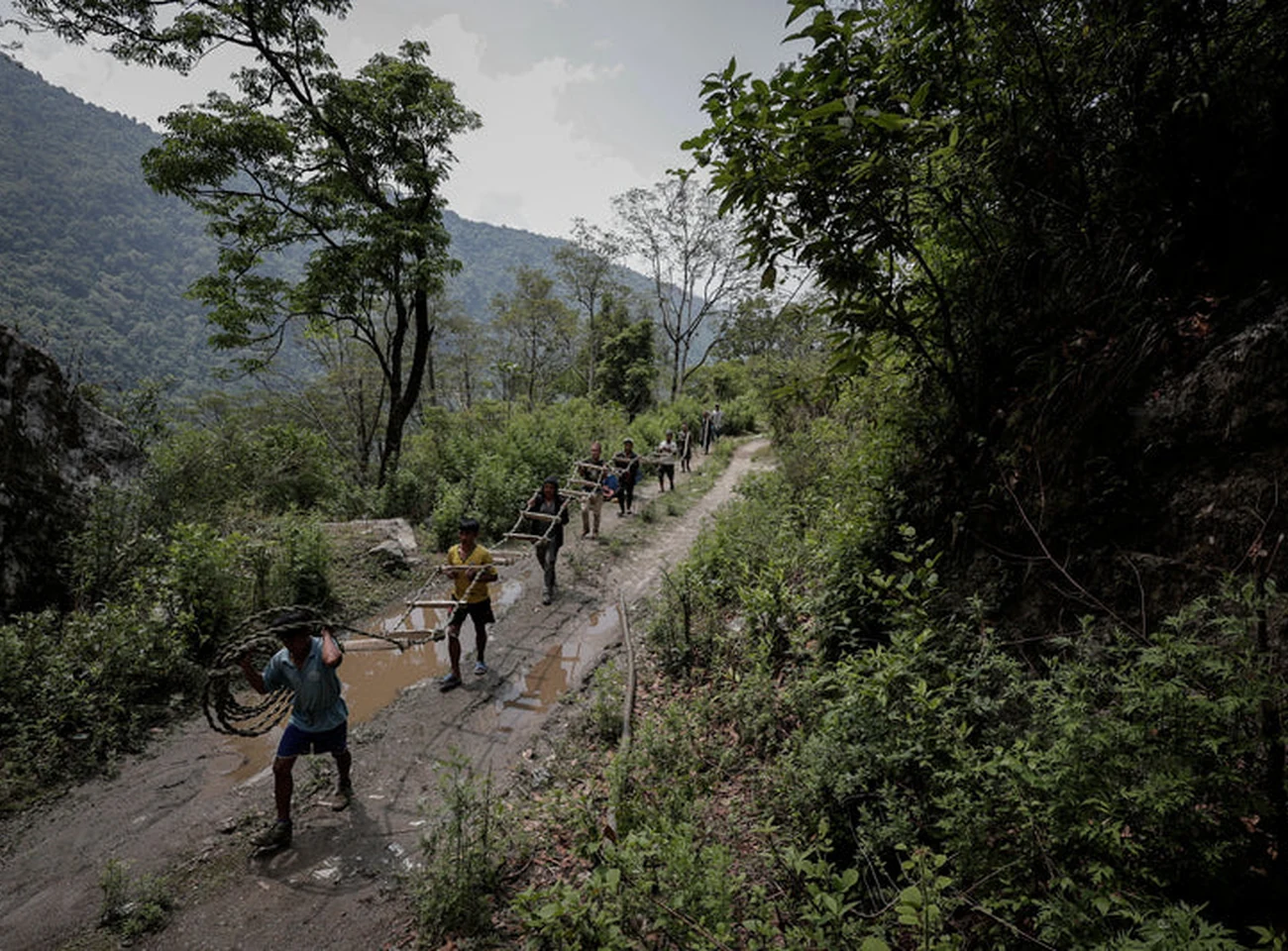 Nepal honey hunters walking along a mountain trail